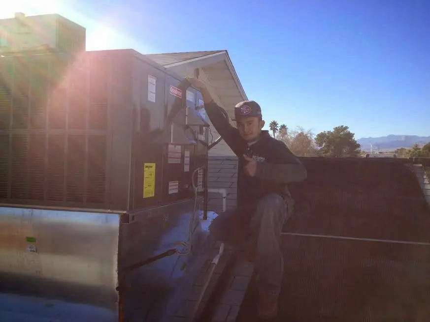HVAC technician performing Heat Pump Repair on a rooftop unit in Princeton